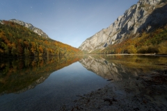 Reflections in Leopoldsteinersee in autumn moonlight with stars