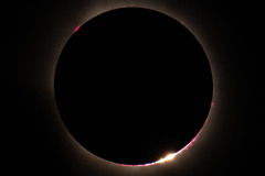 The firstlight of the sun at the end of totality showing Baileys Beads
